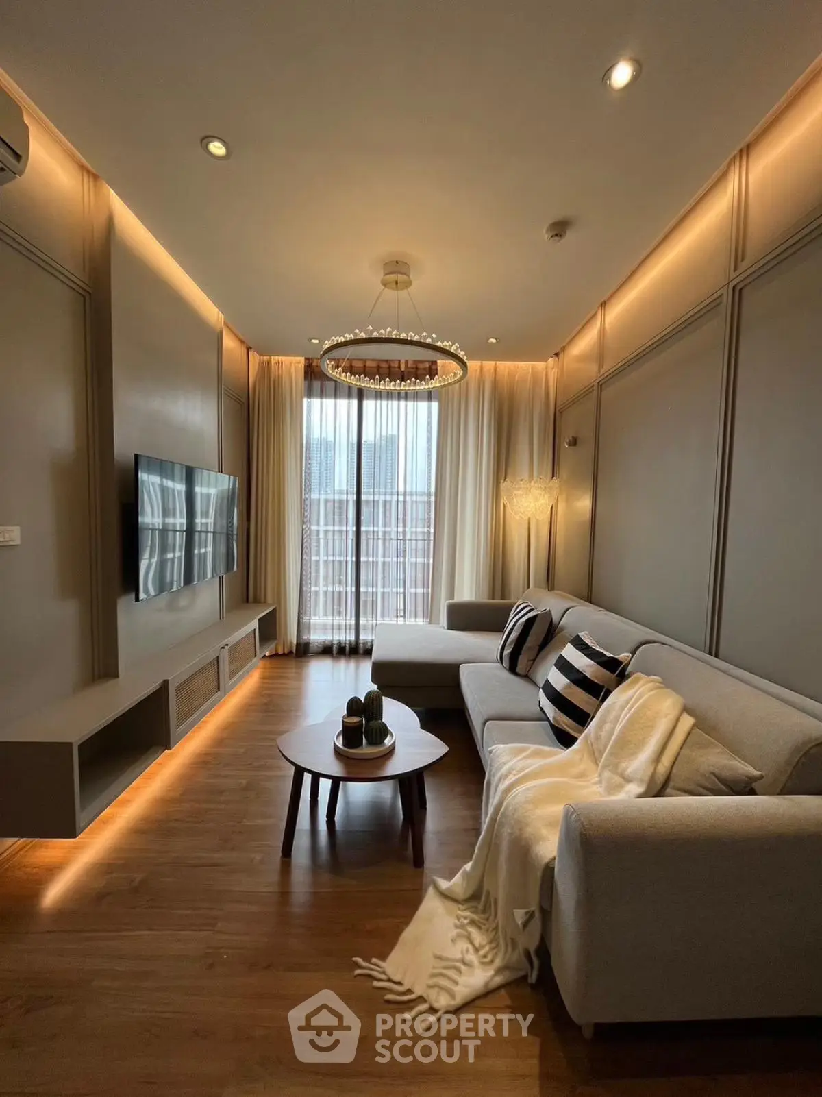 Elegant living room with modern decor, cozy sofa, and ambient lighting, perfect for relaxation and entertainment.