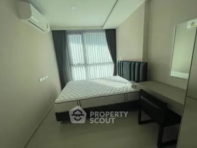 Modern bedroom with natural light, featuring a comfortable bed and sleek furniture in a minimalist design.