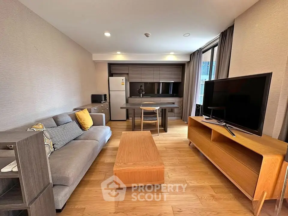 Modern living room with stylish furniture and open kitchen layout