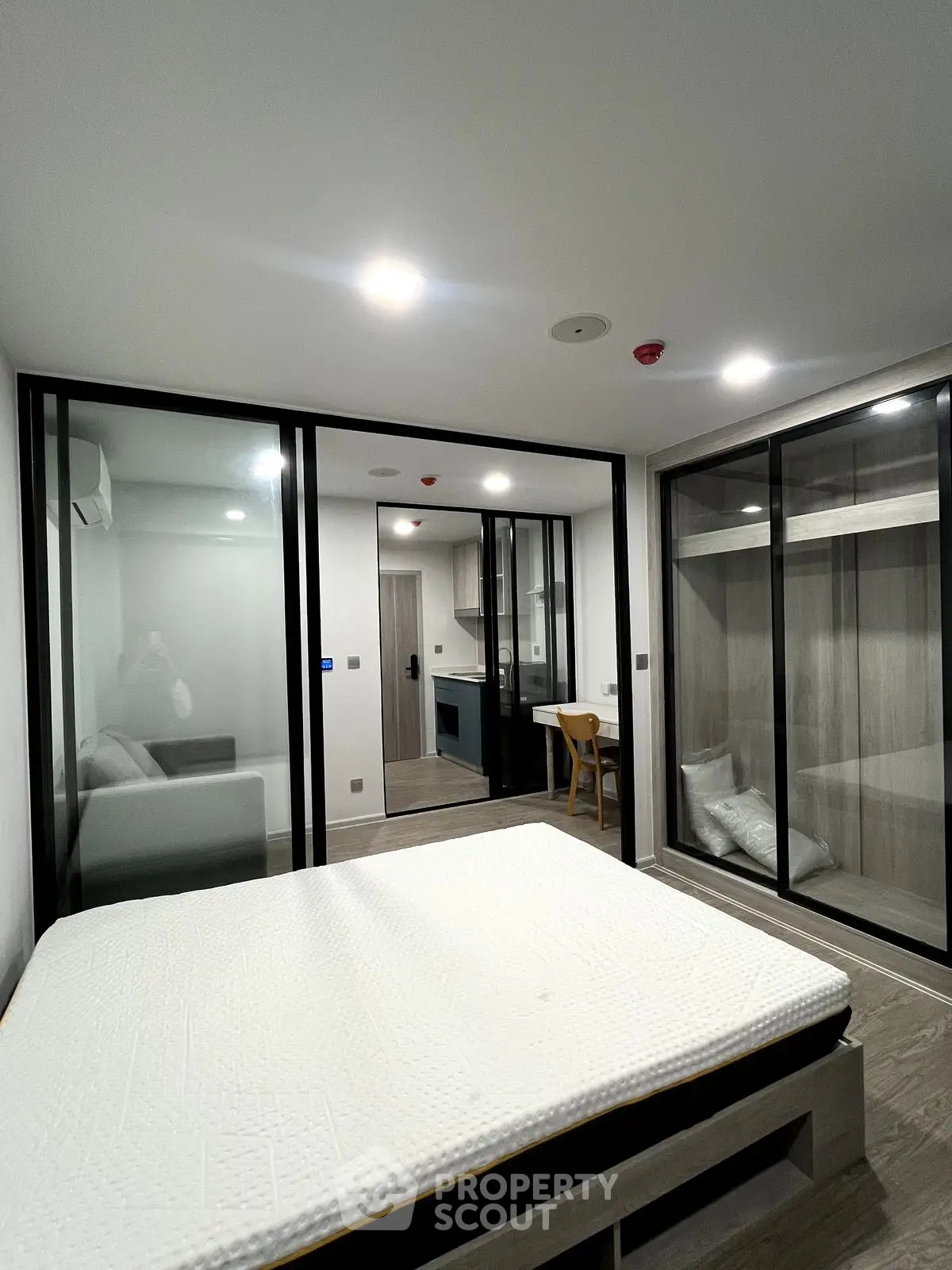Modern bedroom with glass partitions and minimalist design in a stylish apartment