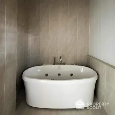 Luxurious bathroom with elegant freestanding bathtub and modern tile design.