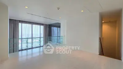 Spacious modern interior with large windows and elegant flooring, offering a bright and airy ambiance.
