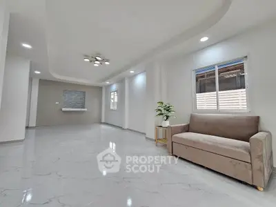 Spacious modern living room with elegant lighting and sleek tile flooring