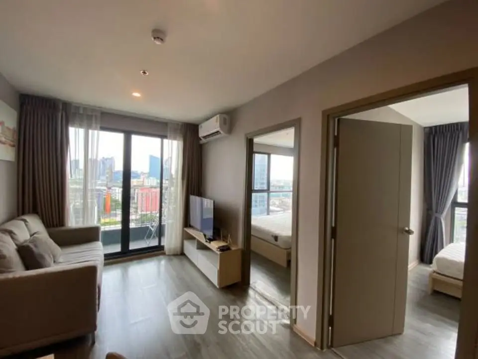 Modern apartment living room with balcony and bedroom view