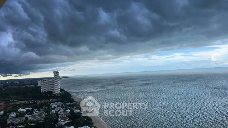 Stunning ocean view from high-rise building with dramatic clouds