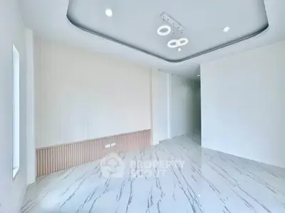 Modern minimalist living room with elegant lighting and marble flooring