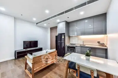 Modern open-plan living room with sleek kitchen and stylish furnishings