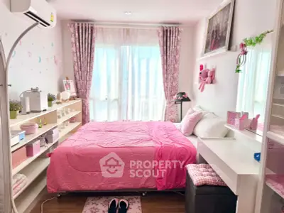 Charming pink-themed bedroom with cozy decor and ample natural light.