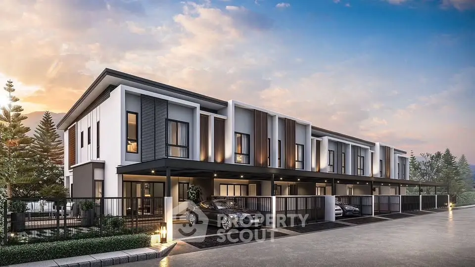 Modern townhouse exterior with sleek design and spacious parking area at sunset.