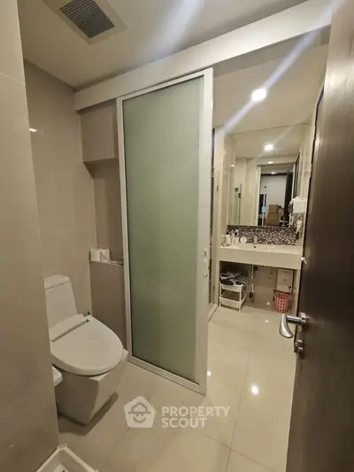 Modern bathroom with sleek design and glass door