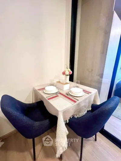 Cozy dining nook with elegant table setting and plush blue chairs