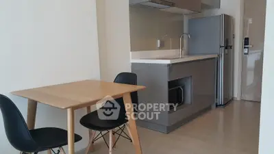 Modern kitchen with sleek cabinetry and compact dining area