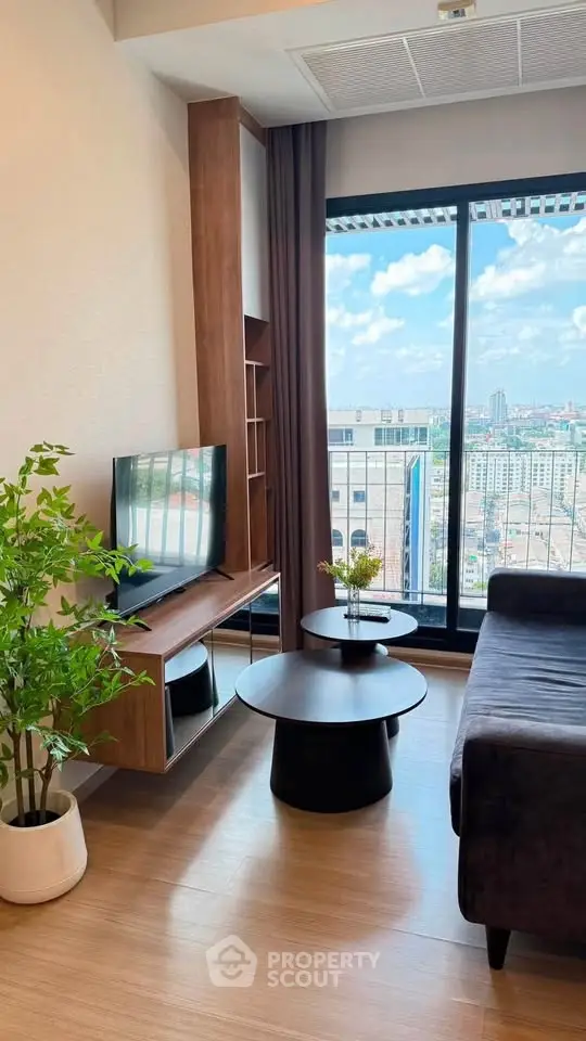 Modern living room with stunning city view, stylish furniture, and natural light.