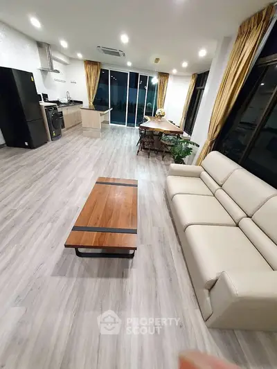 Spacious modern living room with open kitchen and elegant decor