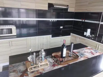 Modern kitchen with sleek black countertops and stylish appliances