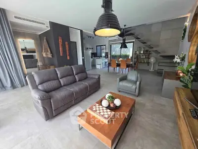 Spacious modern living room with stylish decor and open layout, featuring elegant furniture and natural light.