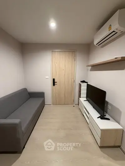 Modern living room with sleek furniture and air conditioning, perfect for urban living.