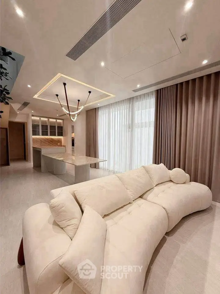 Luxurious modern living room with elegant sofa and open kitchen layout