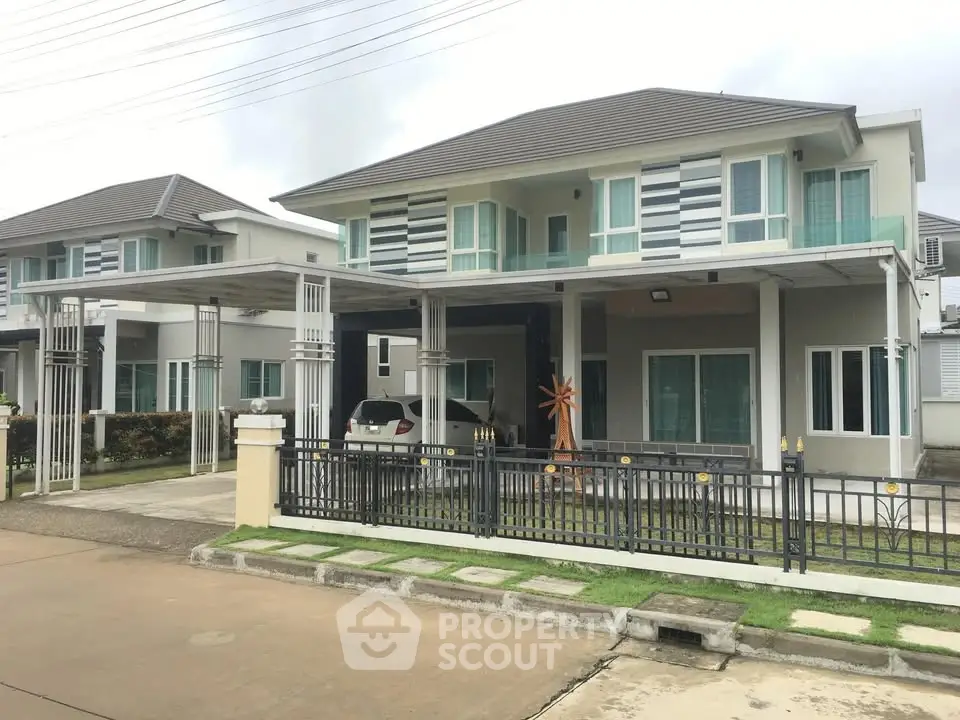 Modern two-story house with carport and stylish facade in suburban neighborhood.