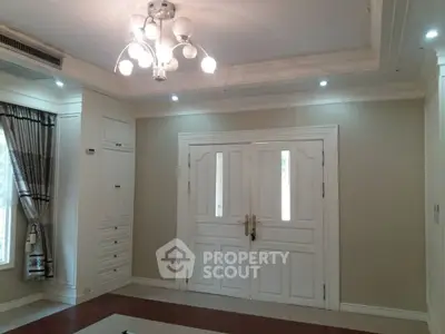 Elegant living room with stylish lighting and classic double doors