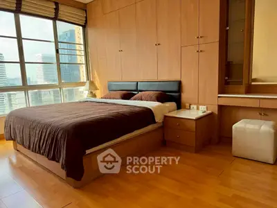 Luxurious bedroom with stunning city view and elegant wooden furnishings