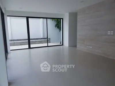 Spacious modern living room with large windows and minimalist design