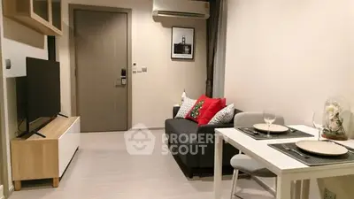 Modern living room with cozy sofa, dining table, and wall-mounted TV in stylish apartment.