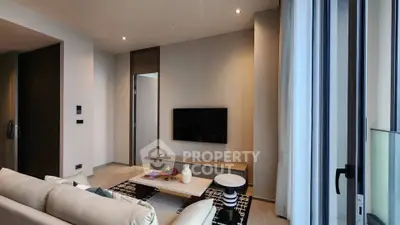 Modern living room with sleek design and large windows for natural light.