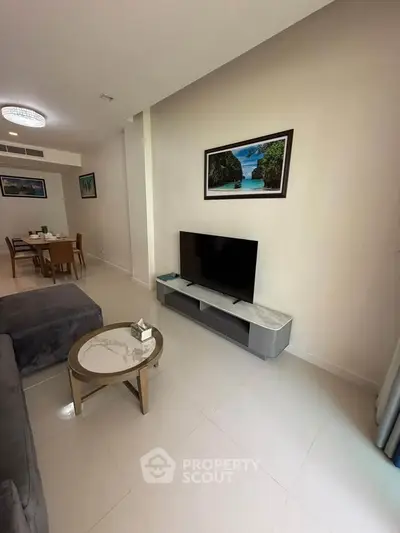 Modern living room with sleek furniture and wall art, perfect for relaxation and entertainment.