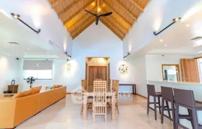 Spacious open-plan living room with high ceilings and modern decor