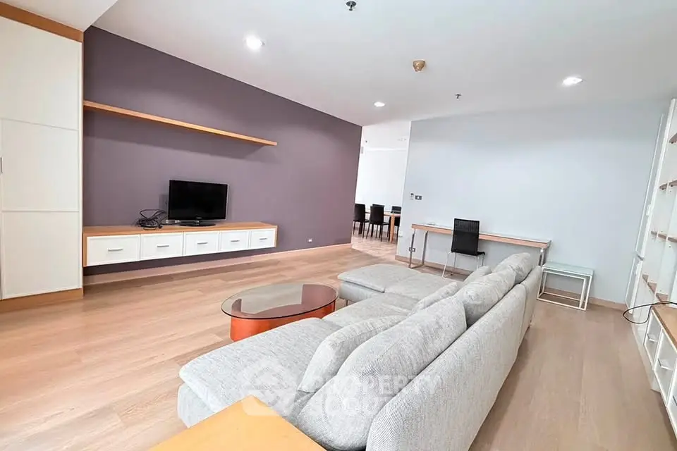 Spacious modern living room with sleek furniture and wooden flooring