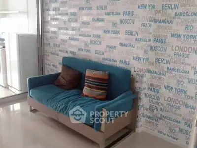 Stylish living room with vibrant blue sofa and city-themed wallpaper