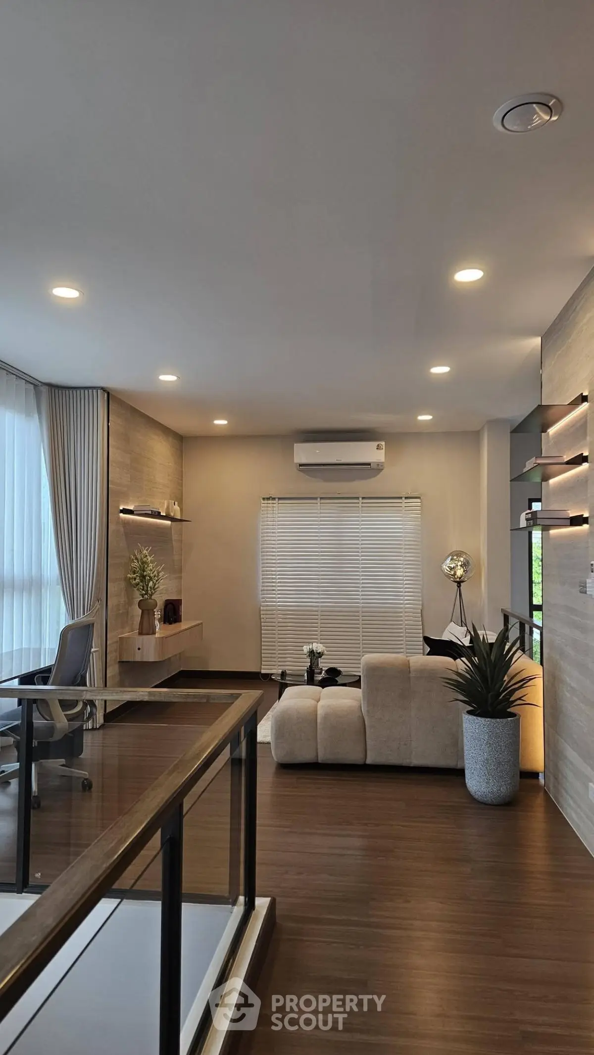 Modern living room with stylish decor, large windows, and cozy seating area, perfect for relaxation and entertainment.