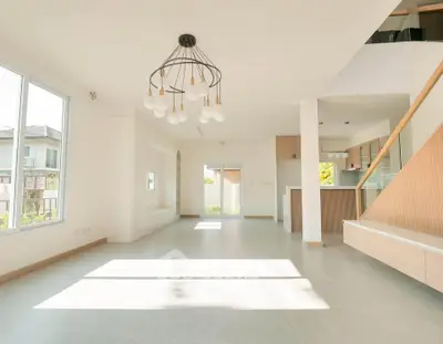 Spacious modern living room with elegant chandelier and natural light