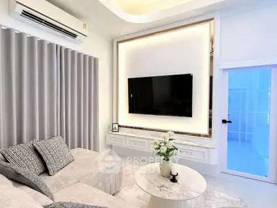 Modern living room with elegant decor and wall-mounted TV