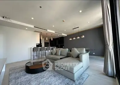 Spacious modern living room with elegant decor and open kitchen layout
