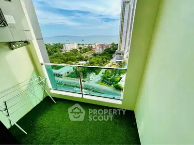 Stunning high-rise balcony with breathtaking ocean view and lush greenery.