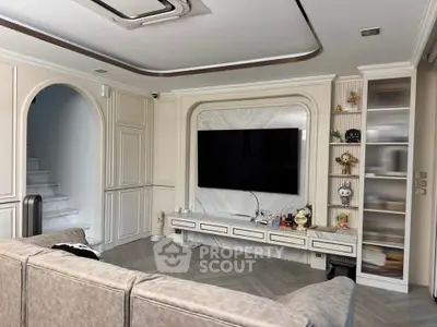 Luxurious living room with modern TV setup and elegant decor