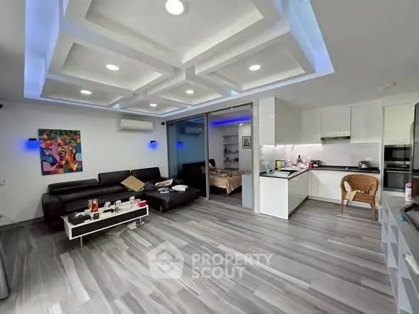 Modern open-plan living room with sleek kitchen and stylish decor