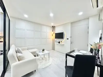Modern living room with sleek white furniture and stylish decor