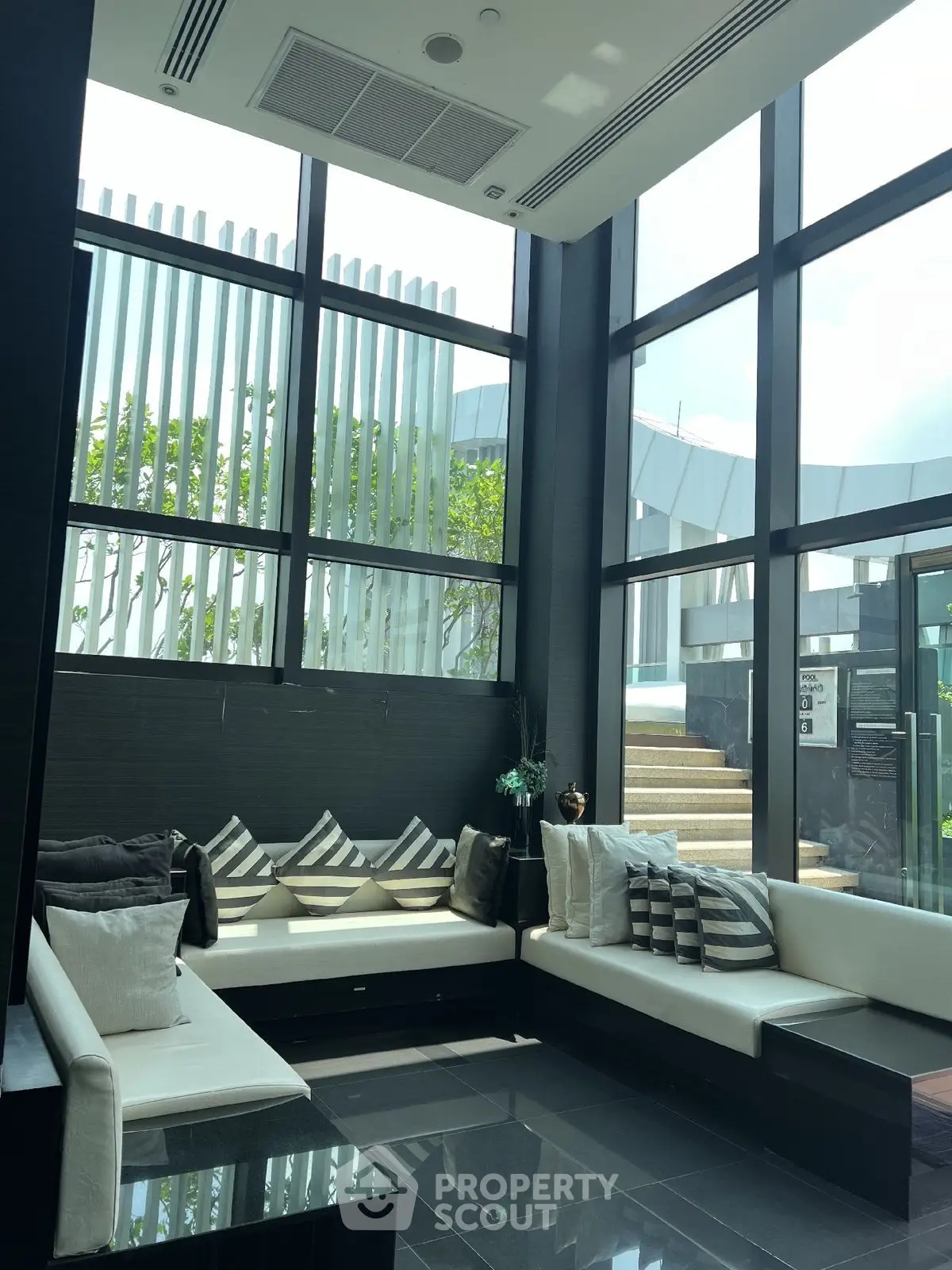 Luxurious modern living room with high ceilings and large windows