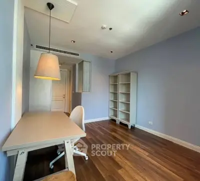 Spacious study room with modern desk and shelving, perfect for productivity.