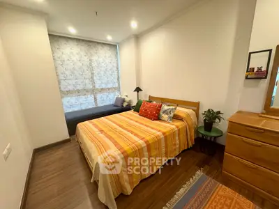 Cozy bedroom with stylish decor and natural light, featuring a comfortable bed and elegant furnishings.