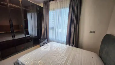 Cozy bedroom with large wardrobe and natural light