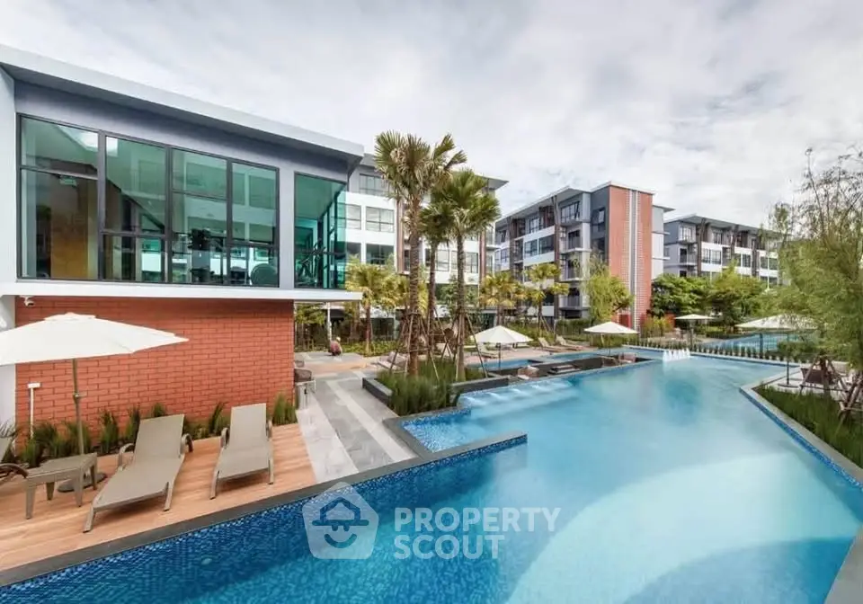 Luxurious apartment complex with stunning pool and modern architecture, perfect for resort-style living.