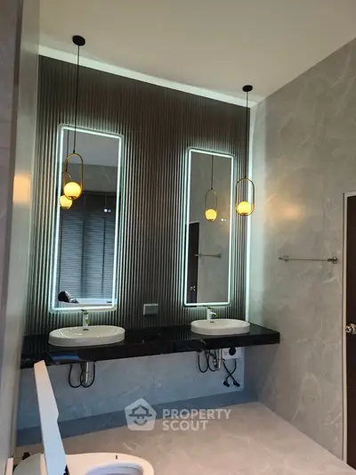 Luxurious modern bathroom with dual sinks and elegant lighting