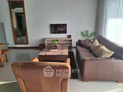 Spacious living room with cozy leather sofas and modern decor