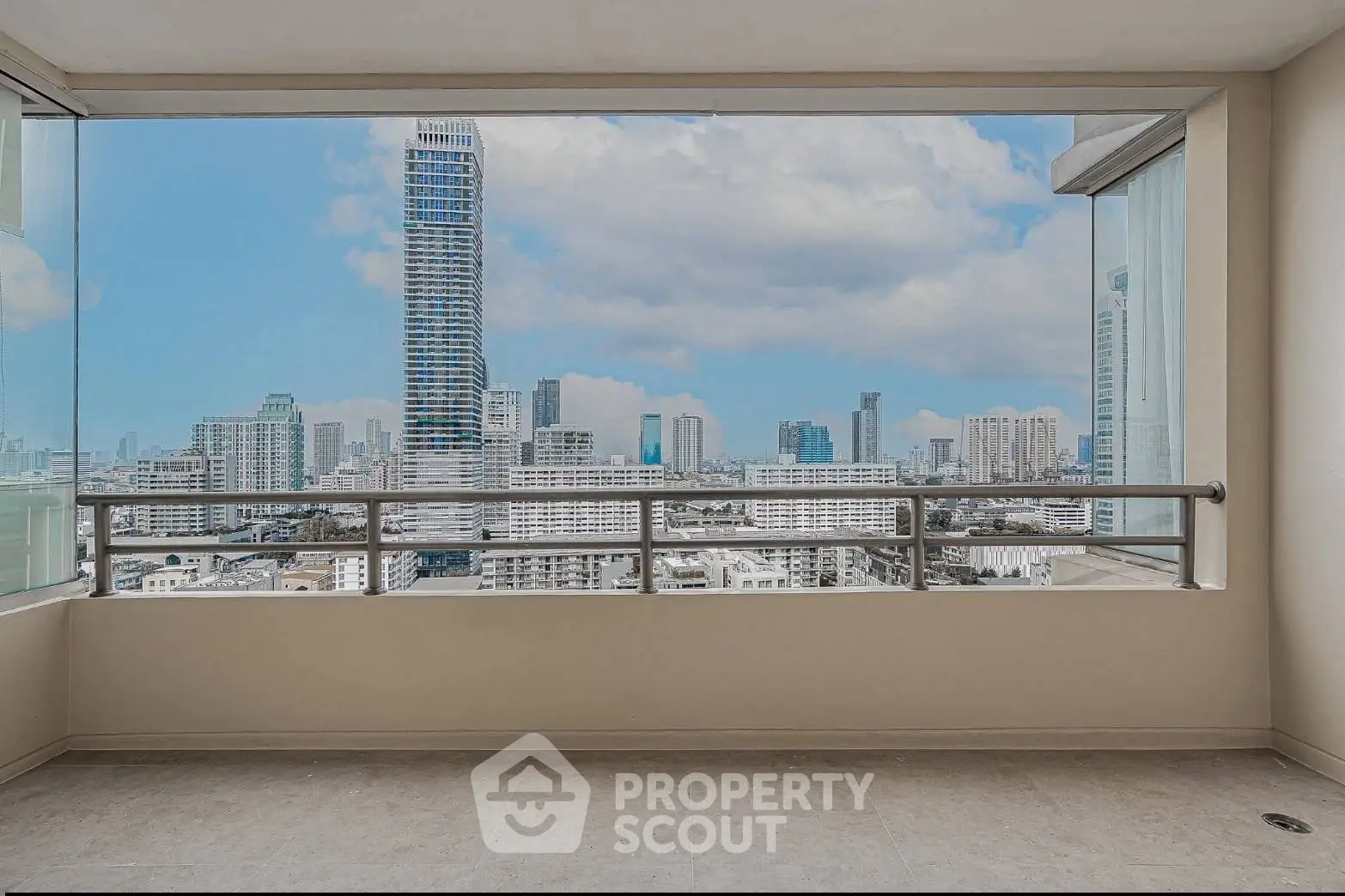 Stunning cityscape view from a spacious balcony in a modern high-rise apartment.