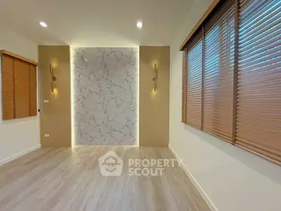 Modern empty room with stylish wall paneling and wooden blinds
