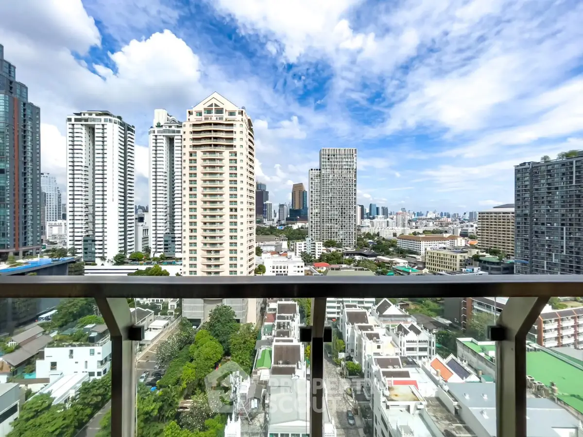 Stunning cityscape view from high-rise balcony with modern skyscrapers and clear blue sky.